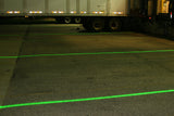 Green DockRight laser lines guiding trucks at an exterior loading dock at night