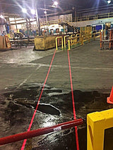 Red DockRight laser walkway lines staying visible on wet and dry warehouse floor