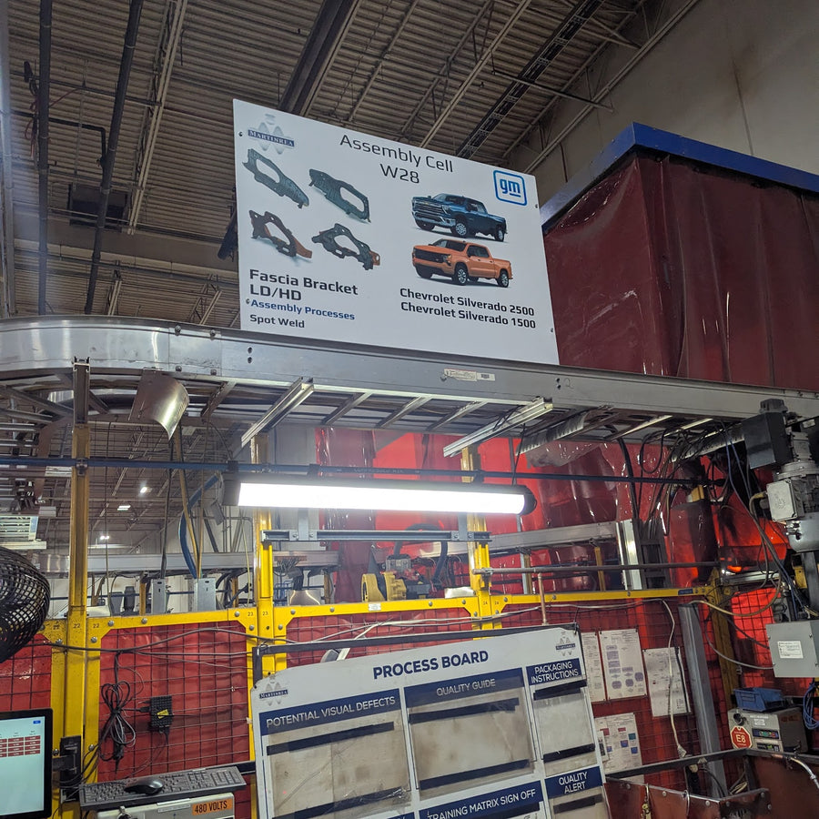 Overhead assembly cell sign above a production cell in an automotive plant
