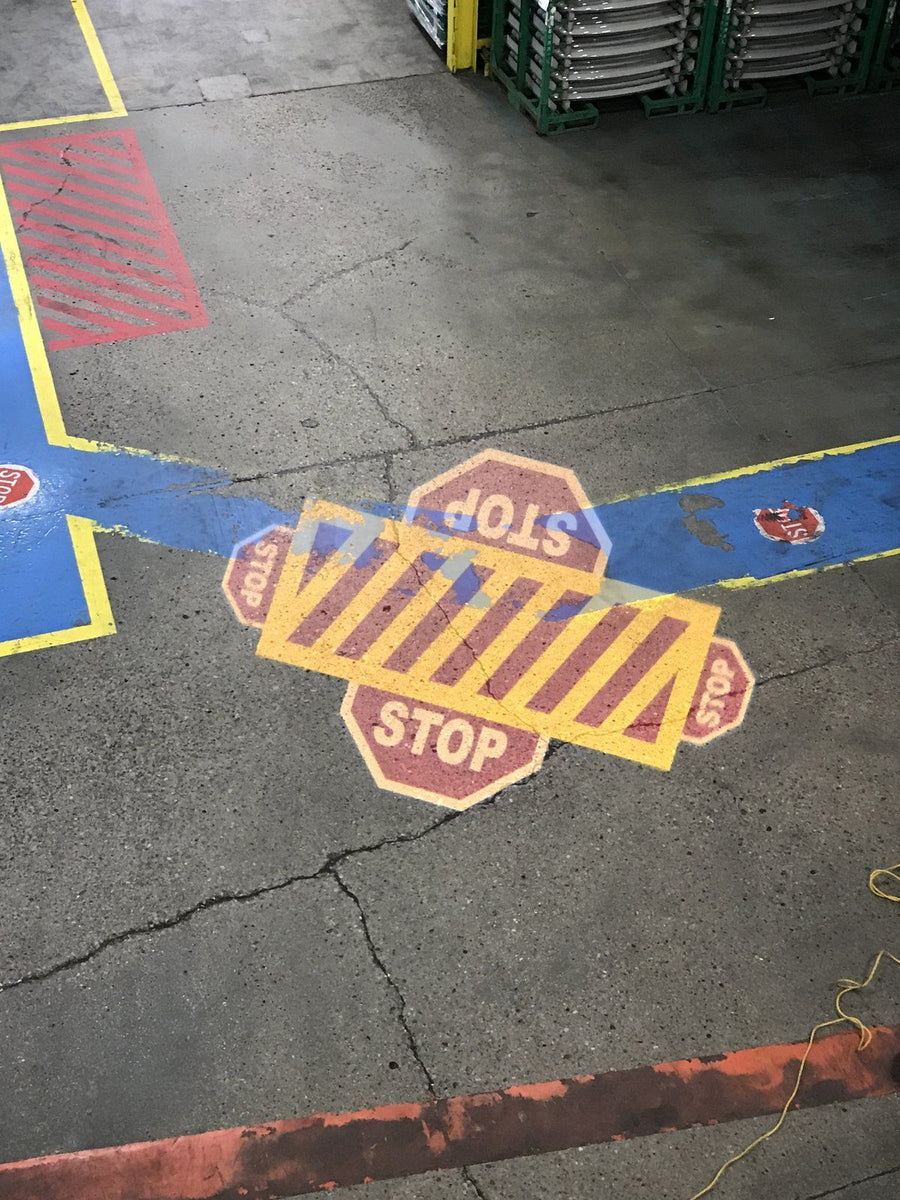 Projected crosswalk and blue walkway on a plant floor